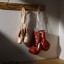 Boxing gloves and ballet shoes hanging in dressing room